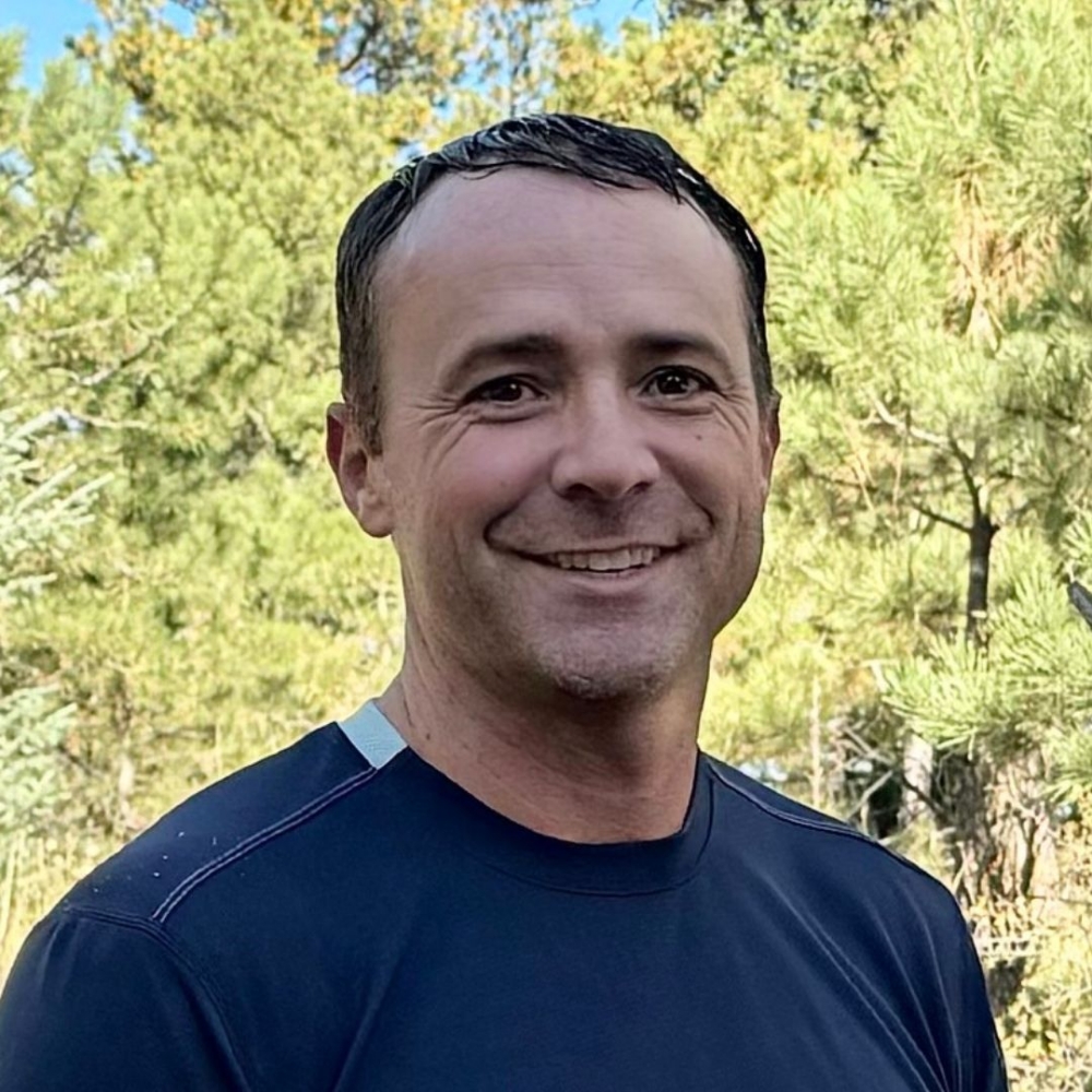 David, team member, smiling in a navy shirt