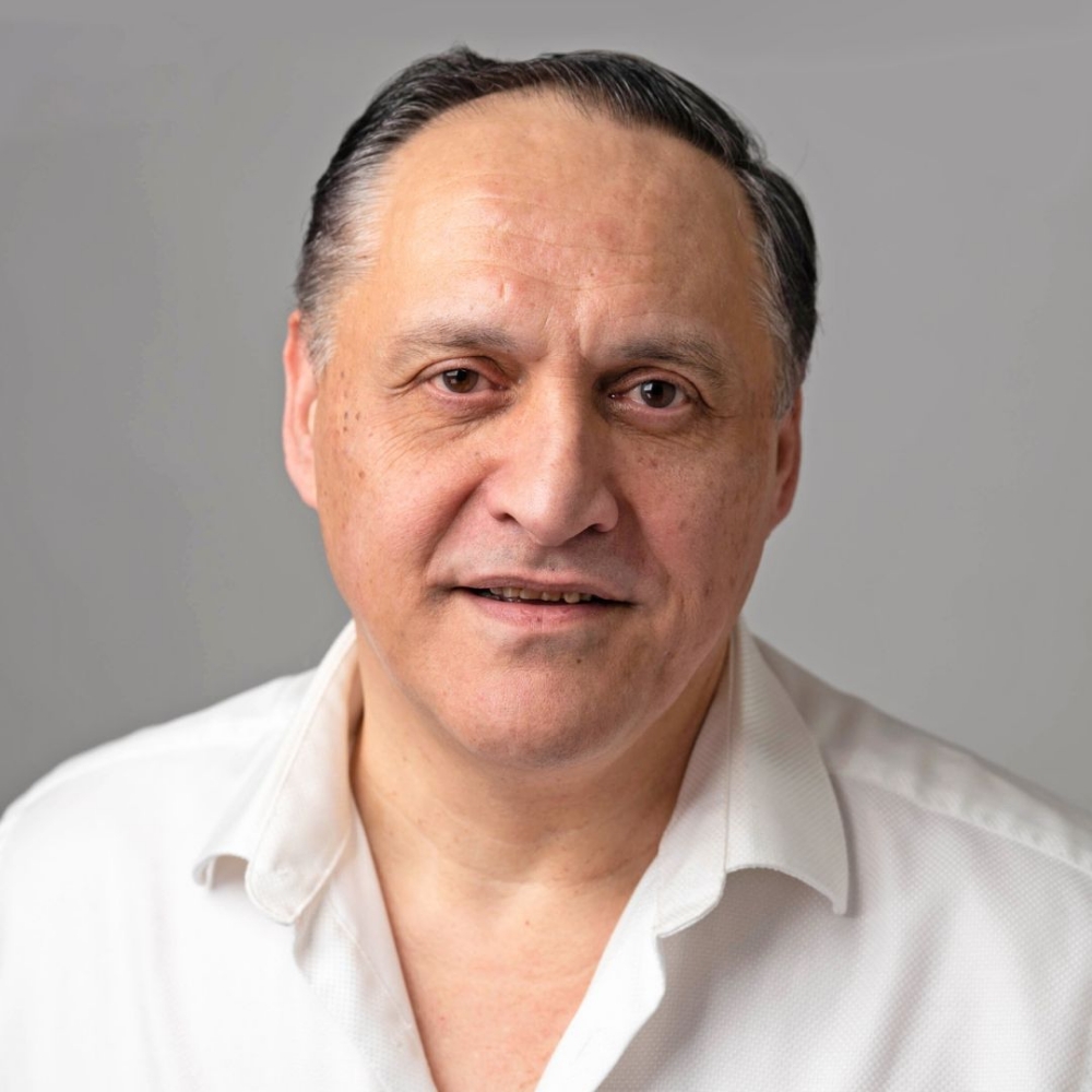 Michael, team member, smiling in a white shirt